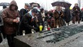 Holocaust survivors light memorial candles at the 63rd anniversary of the liberation of Auschwitz.