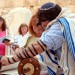 A woman reads from the Torah scroll in Jerusalem near the Western (Wailing) Wall. (Photo by Josh Evnin)